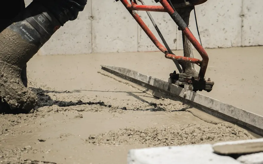Power screed leveling a shop floor pour